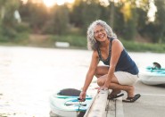 Woman about to board a paddleboard