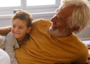 Grandfather and grandson playing on floor